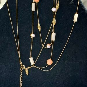 NY gold tone long floating necklace